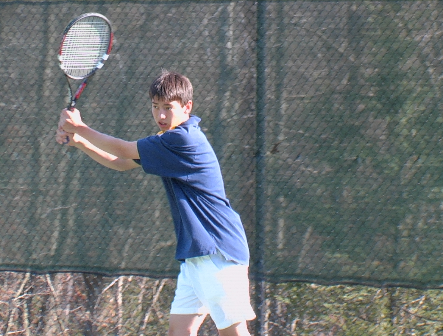 Eliot Jia '06 uncoils a backhand return.