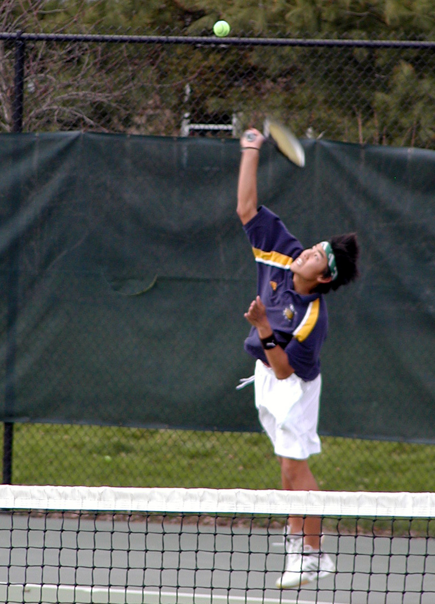 Ming Ong '05 delivering a serve.