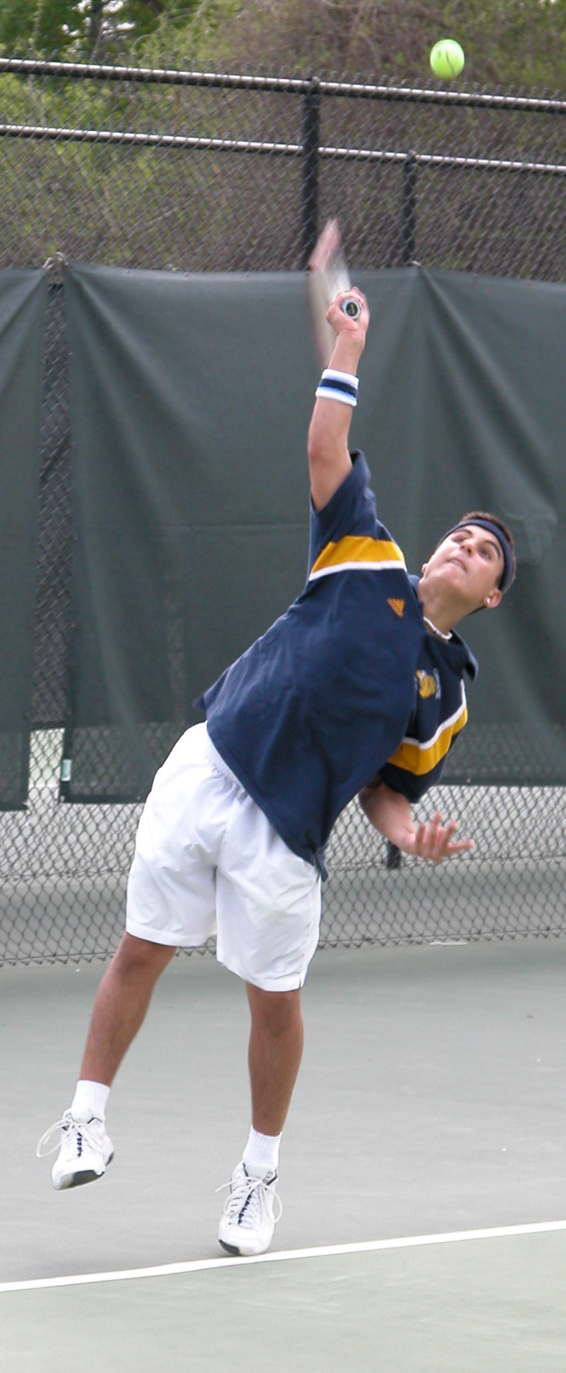 Alex Yimoyines '06 serves.
